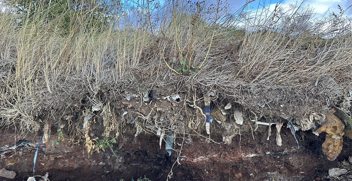 Soft earth showing evidence of landfill