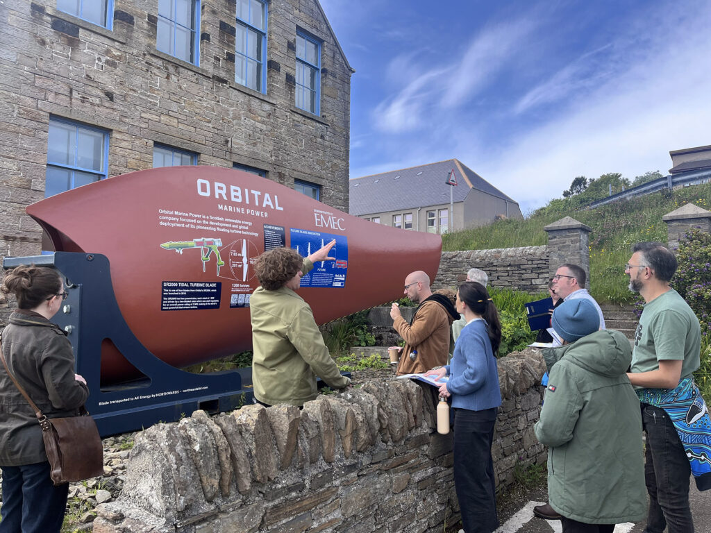 The TRANSECTS team next to a tidal turbine blade