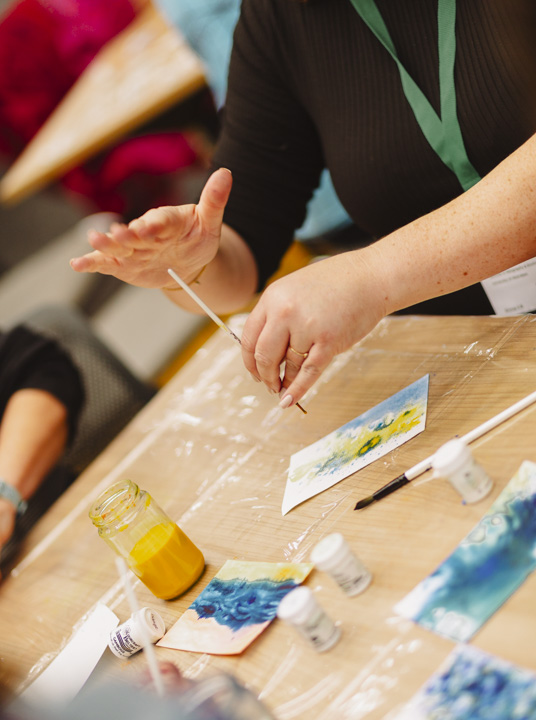Workshop participant using paints