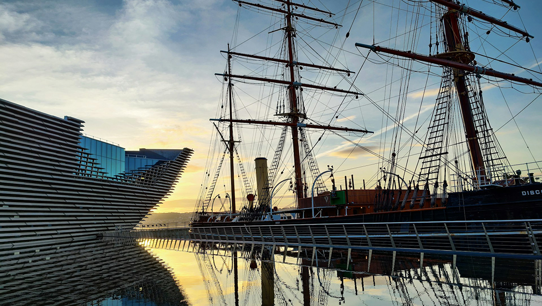 A modern building and old ship in Dundee harbour
