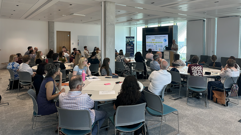Annual Forum delegates gather round tables and listen to a presentation